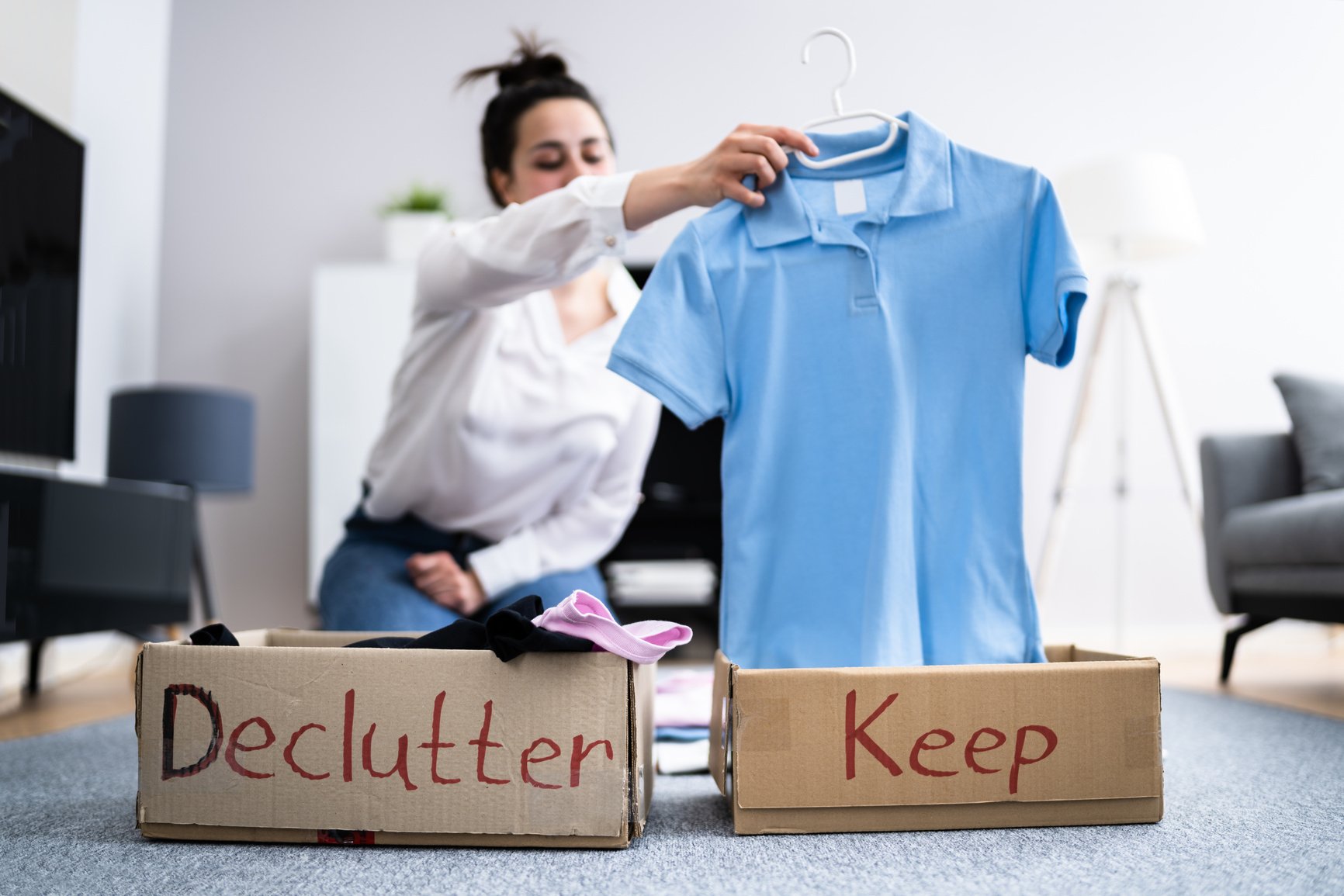 Woman Decluttering Clothes, Sorting